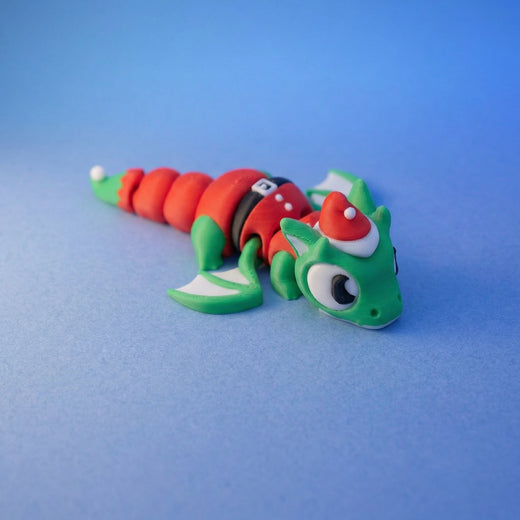 Green elf dragon fidget toy seen from a different angle, showing its festive outfit and fins