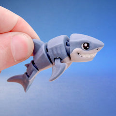 Close-up of Toothy the shark fidget toy's grinning face and articulated fin