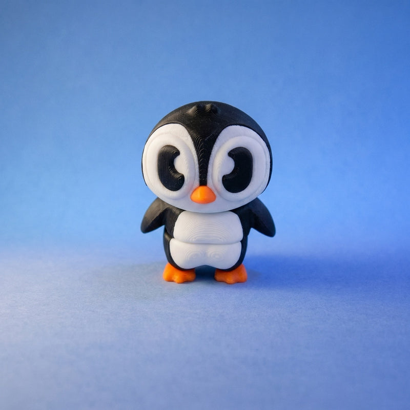 Walter penguin figurine standing alone, showing his two white chest sections against a blue background.