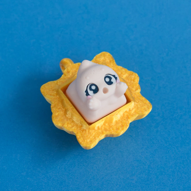 Wispy the beige ghost keycap in gold frame clicker.