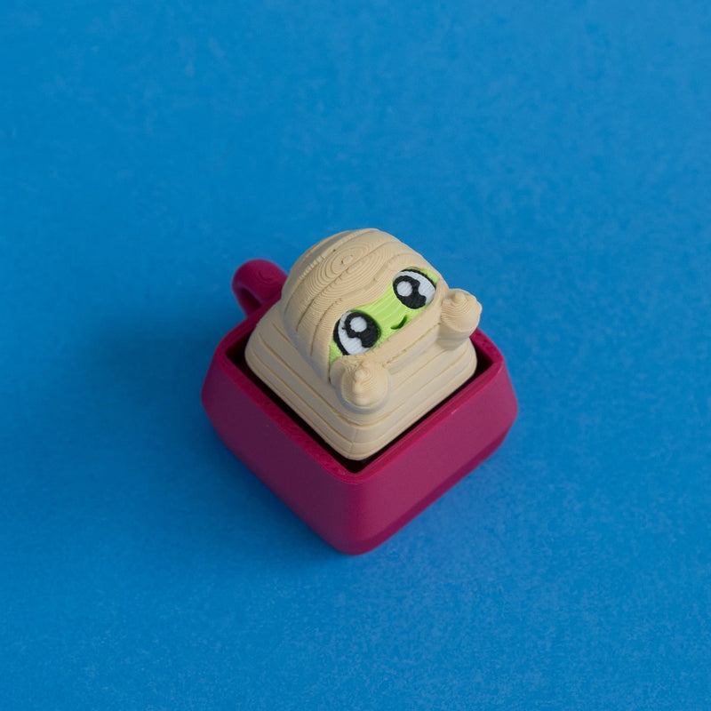 Wrappy the mummy keycap on plum clicker base.