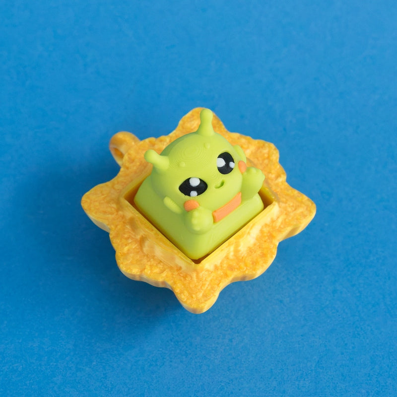 Zibby the bright green alien keycap in gold frame clicker.