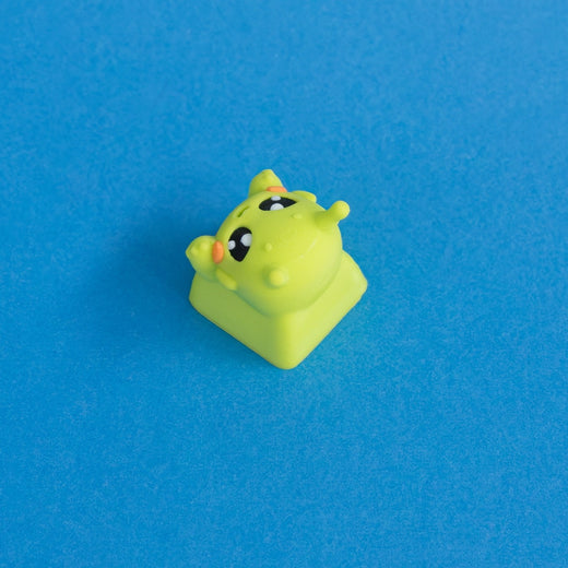 Zibby the bright green alien keycap three quarter view.