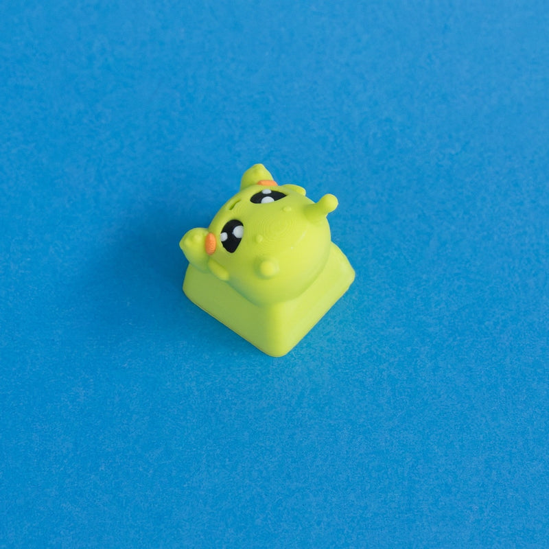 Zibby the bright green alien keycap three quarter view.