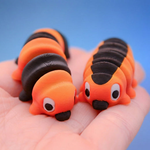 Long orange and black striped caterpillar fidget toy, showing its ribbed segments